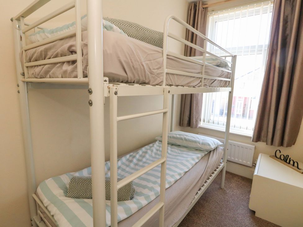 A bedroom with a bunk bed and a window at Home from Home near the Sea Weymouth