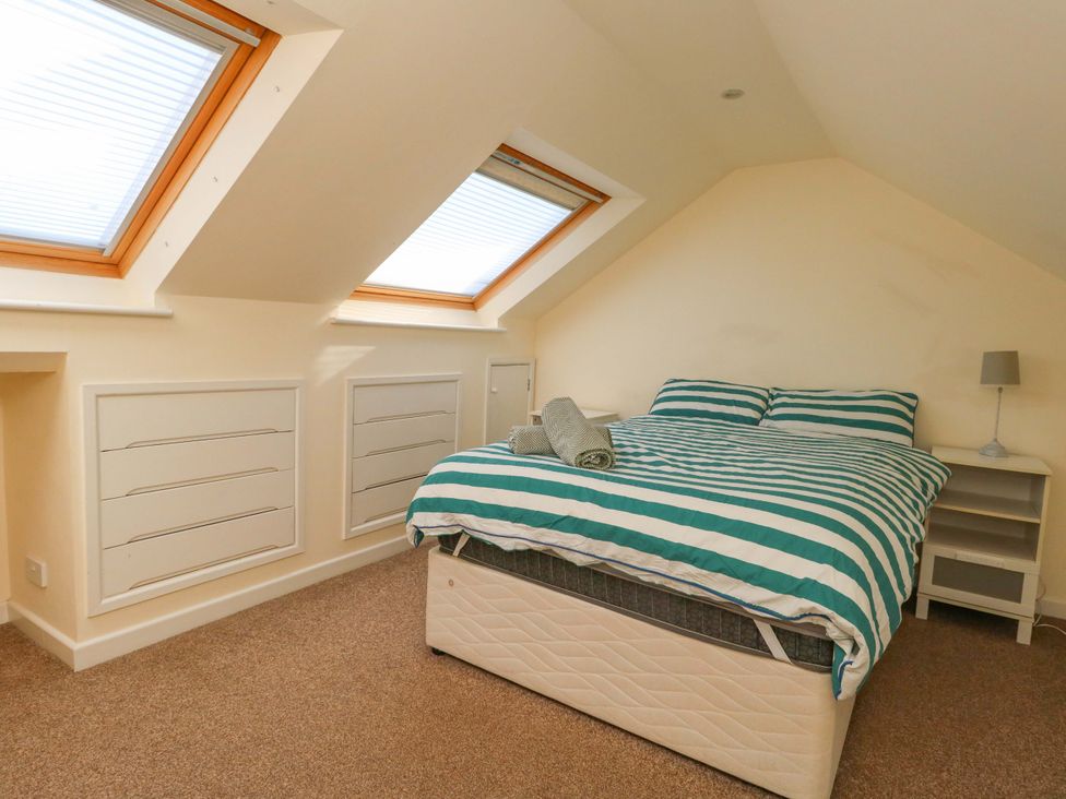 A bedroom with a bed and skylights at Home from Home near the Sea in Weymouth