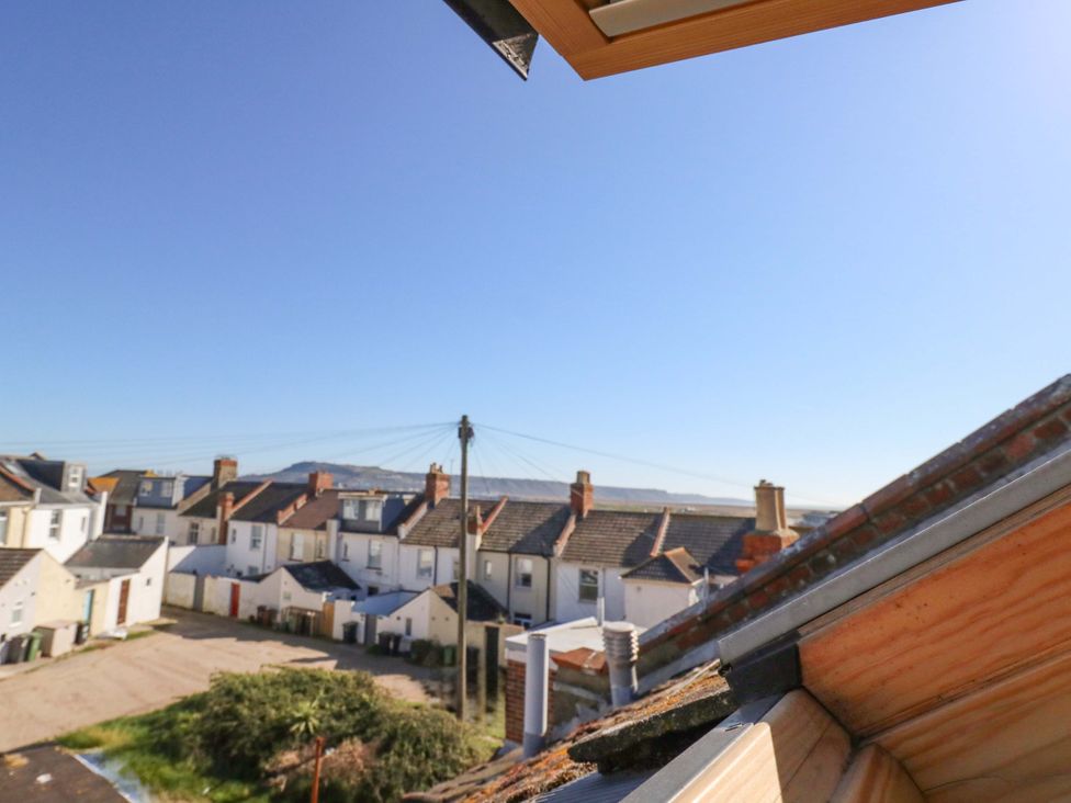 A view of houses and rooftops from a window at Home from Home near the Sea in Weymouth