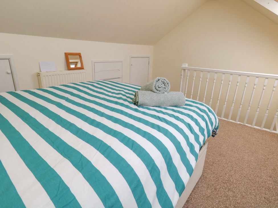 A bedroom with a bed and towels at Home from Home near the Sea Weymouth