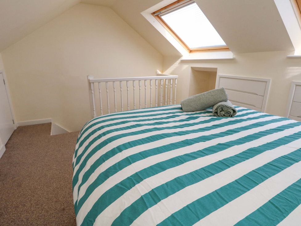 A bedroom with a bed and a roof window at Home from Home near the Sea Weymouth