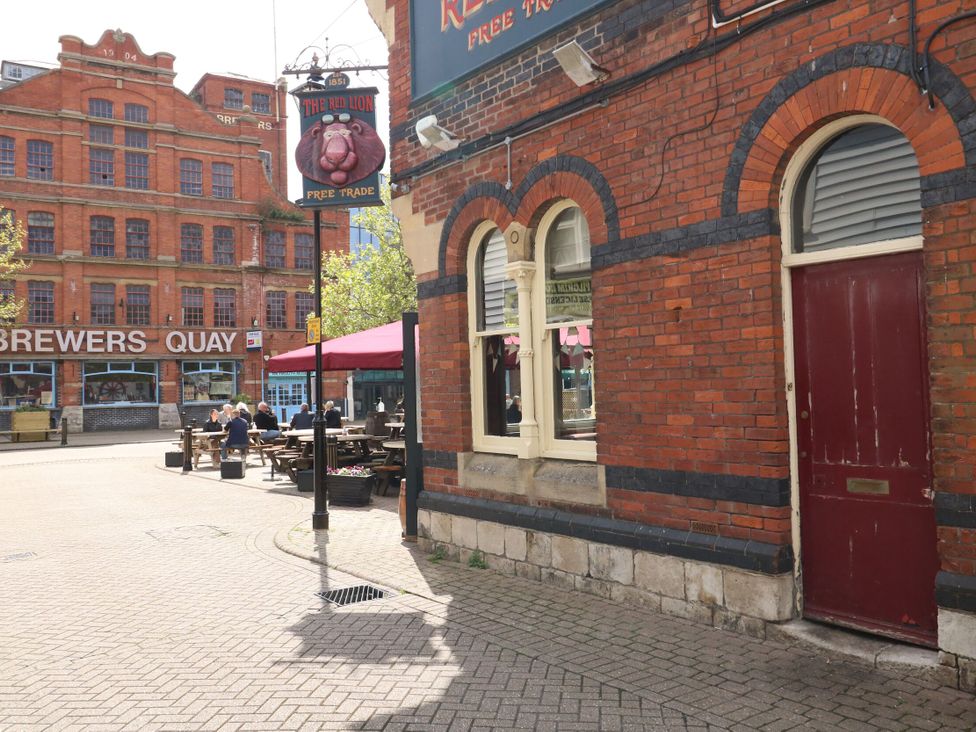 An outdoor area with seating and a pub facade at Home from Home near the Sea Weymouth