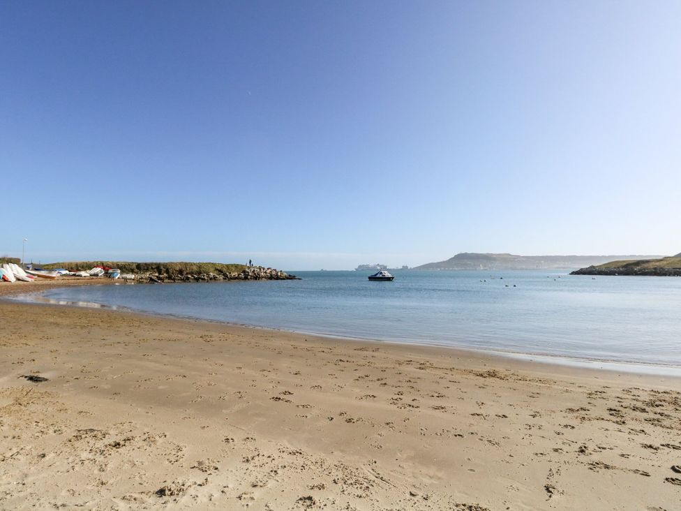 A beach with a boat in water at Home from Home near the Sea in Weymouth