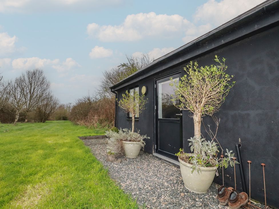 An outdoor view of a wall with planters near the door at Little Hallegan in Camborne
