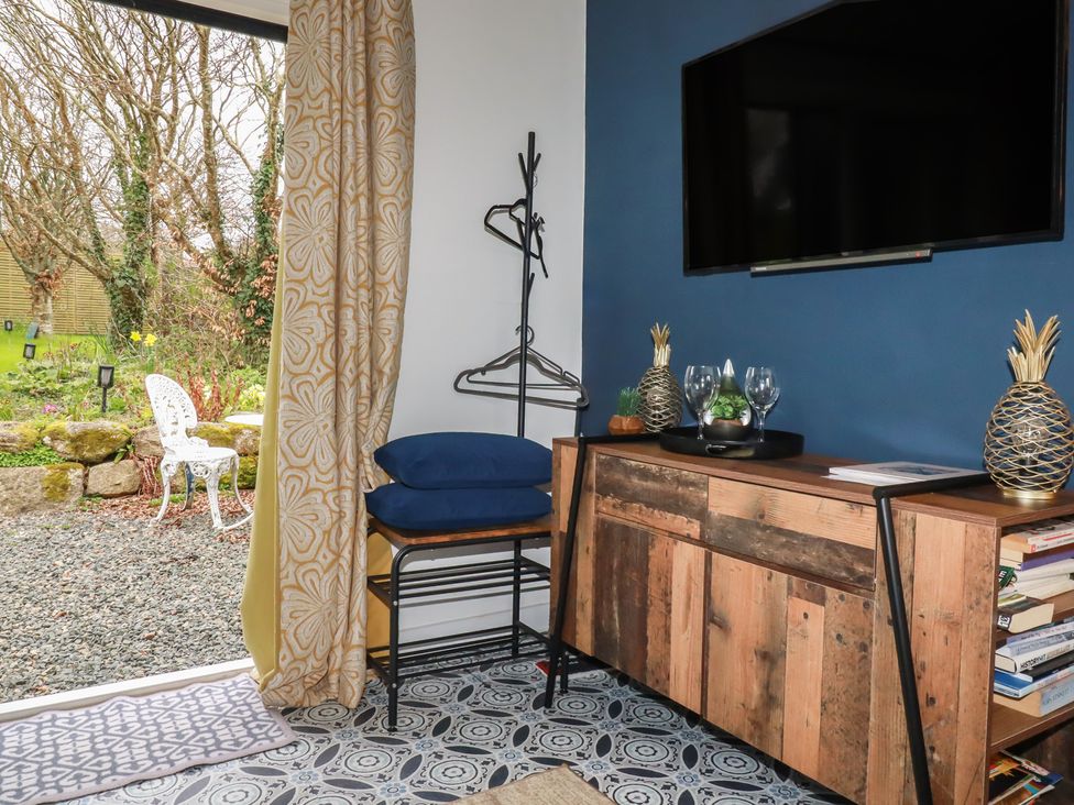 A living room with a television and cabinet at Little Hallegan Camborne