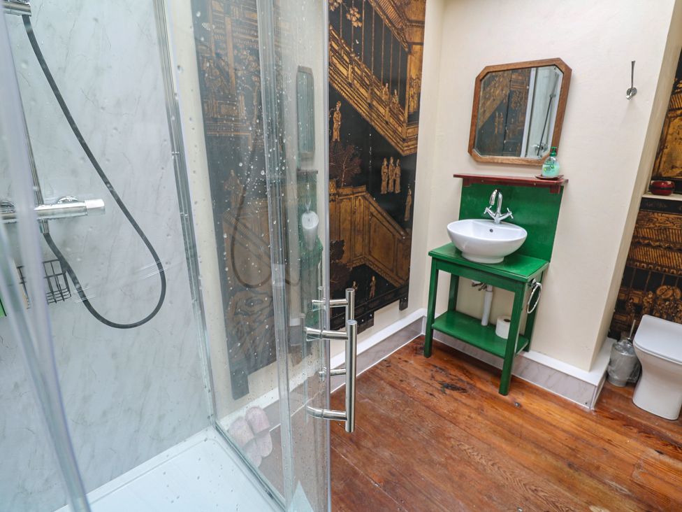 A bathroom with a shower, sink, and toilet at Ninevah in St. Ives
