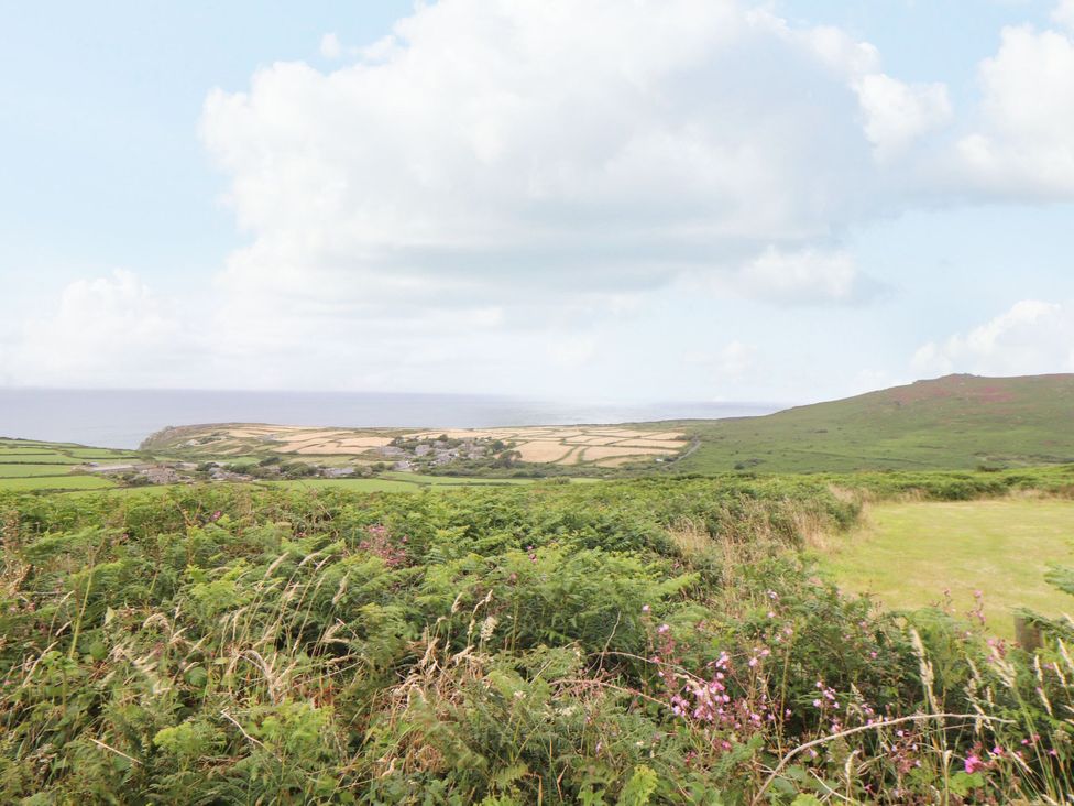 A landscape showing fields and hills with an ocean view at Ninevah in St. Ives