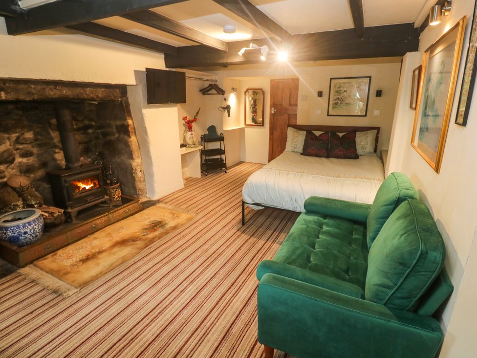 A bedroom with a bed and sofa at Ninevah in Lelant