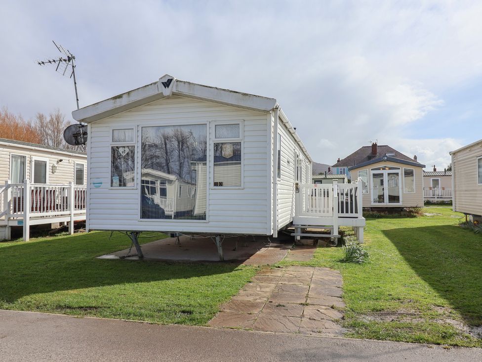 A caravan with steps and a porch at Carvan CP10 Prestatyn