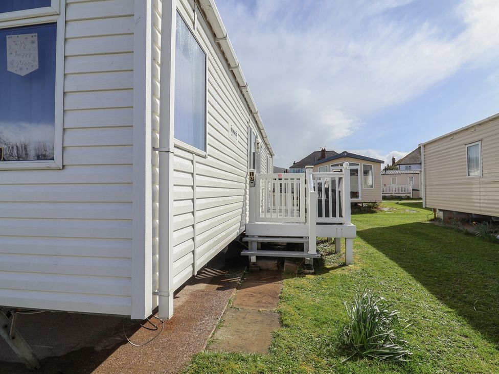 A caravan with steps leading to the entrance at Carvan CP10 in Prestatyn