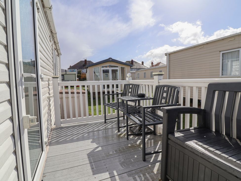 An outdoor patio with furniture at Carvan CP10 Prestatyn