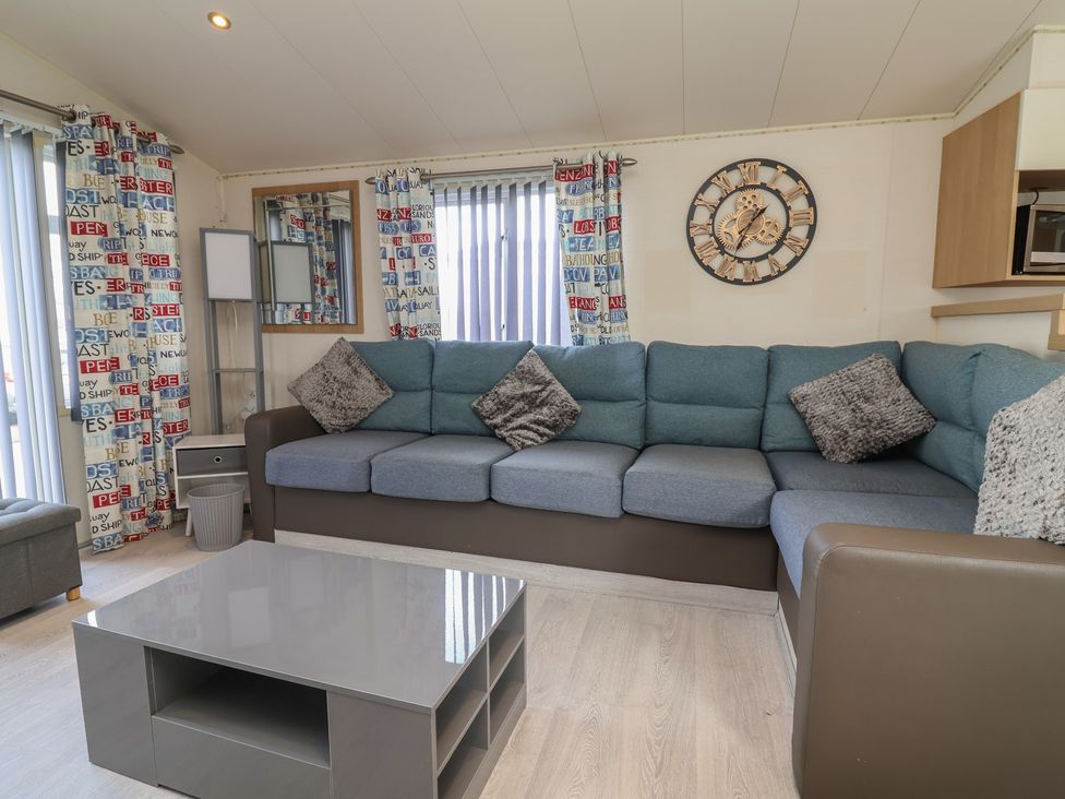 A living room with a sofa and coffee table at Carvan CP10 in Prestatyn
