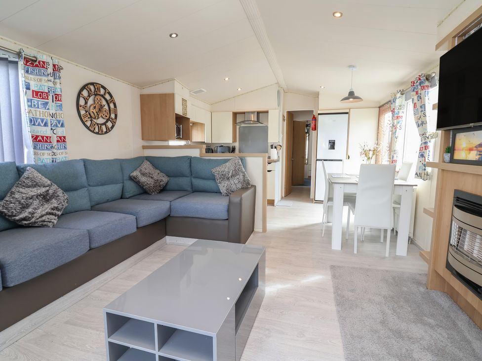 A living room with a sofa and coffee table at Carvan CP10 Prestatyn