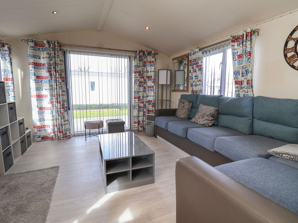 A living room with a sofa and coffee table at Carvan CP10 Prestatyn