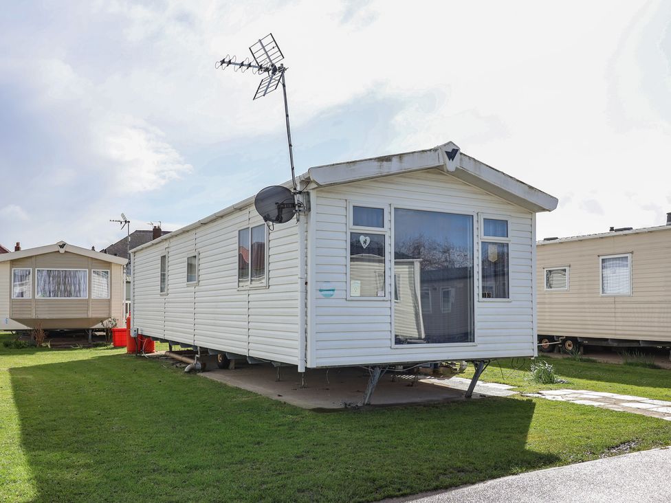 A caravan with a satellite dish and windows at Carvan CP10 Prestatyn