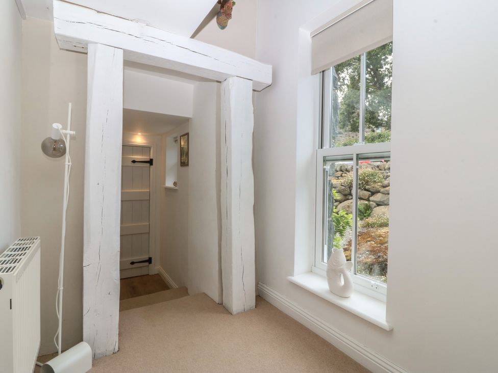 A hallway with a window and door at The Byre in Conwy