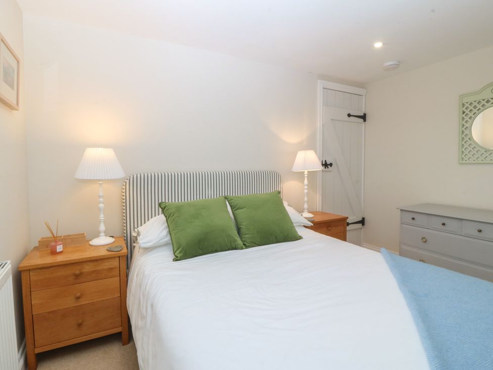 A bedroom with a bed and nightstands at The Byre in Conwy