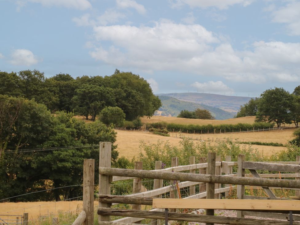 A view of a field and trees at The Byre in Conwy