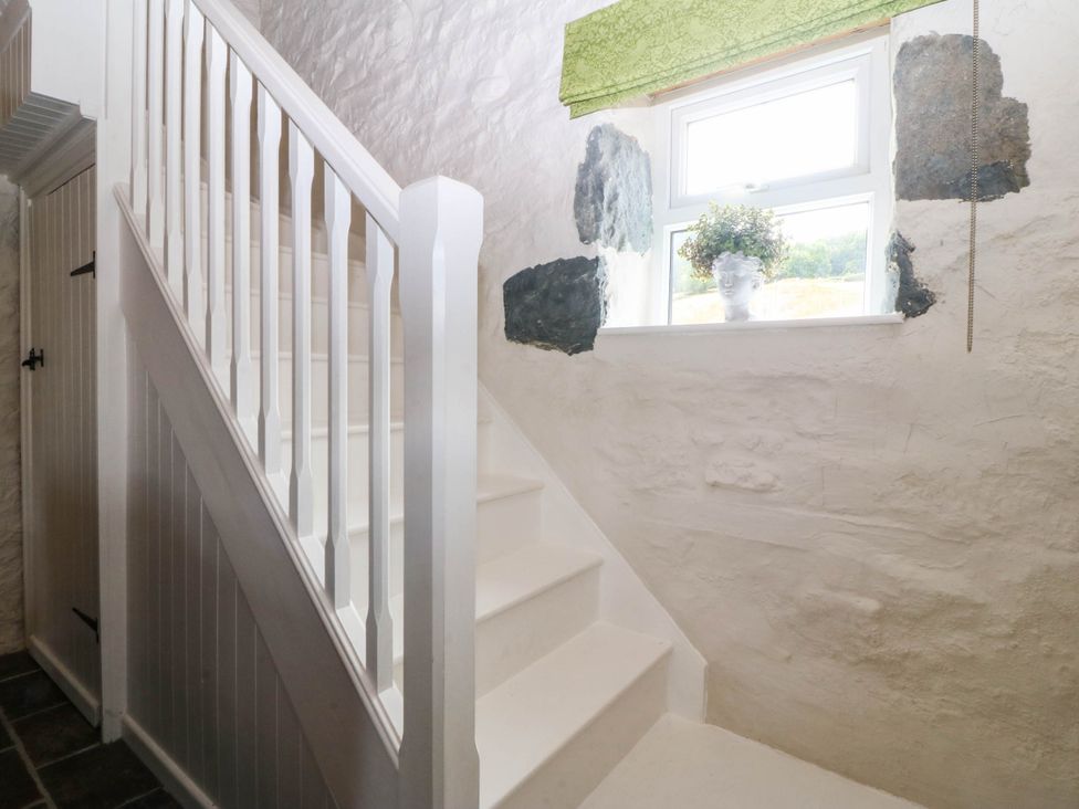 A staircase with a window at Little Oak near Tal-Y-Bont