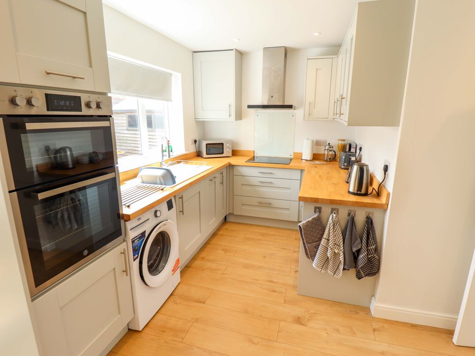A kitchen with appliances and cabinets at Field View in North Walsham