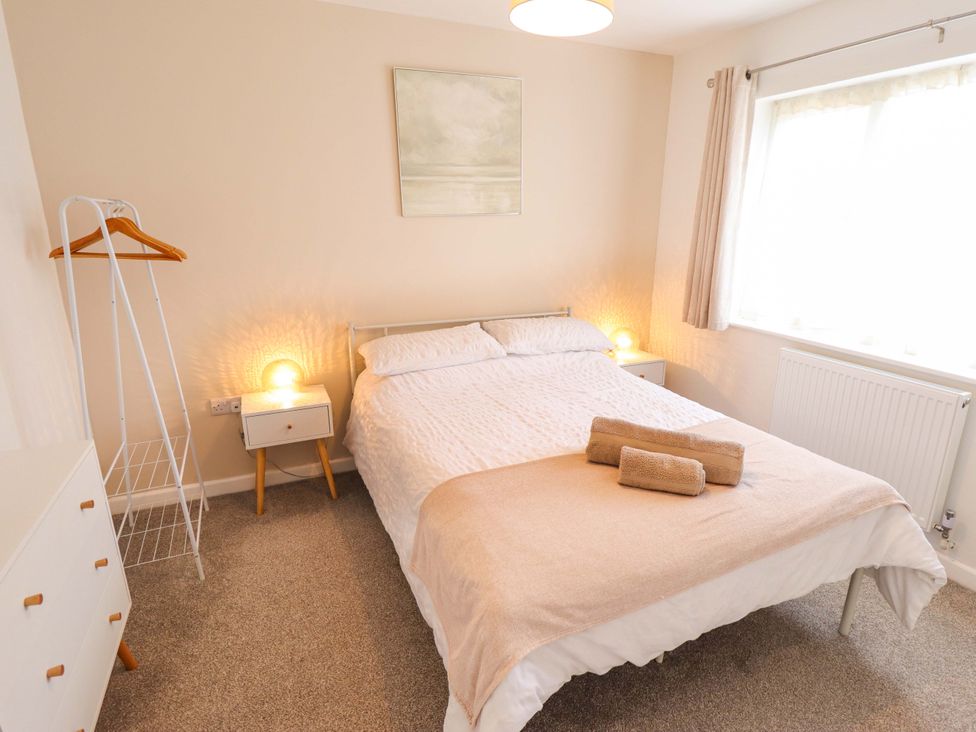A bedroom with a bed and bedside table at Field View in North Walsham