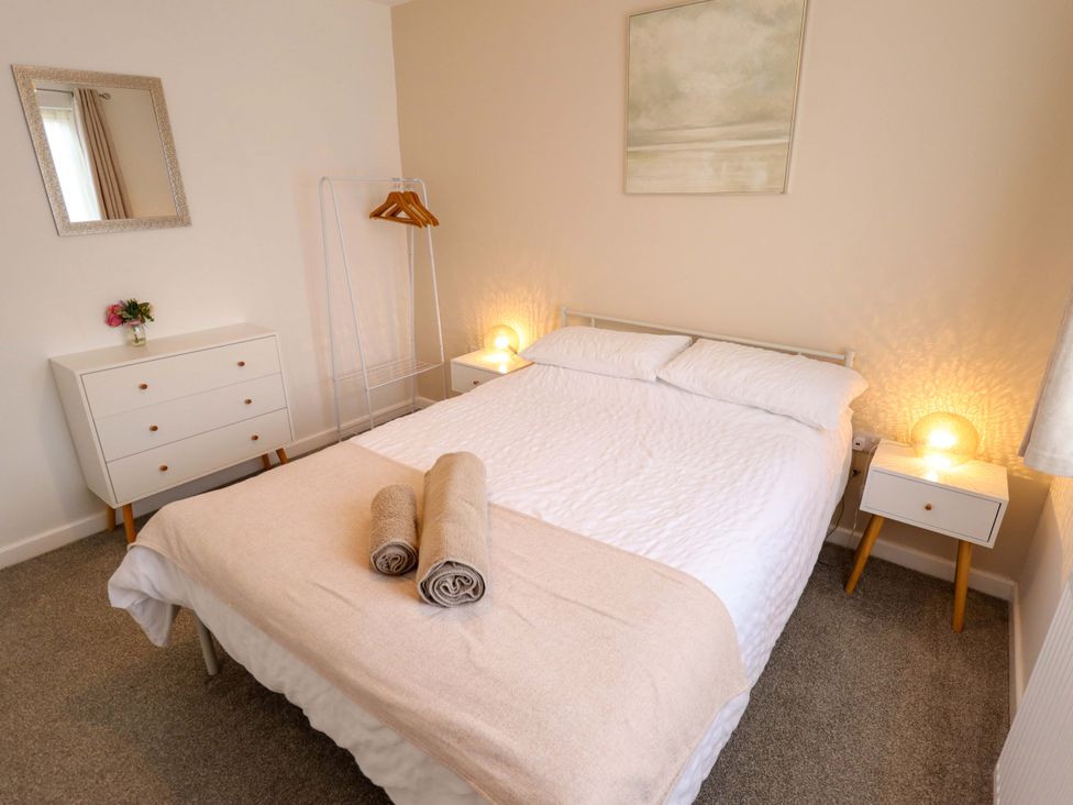 A bedroom with a bed and nightstands at Field View in North Walsham