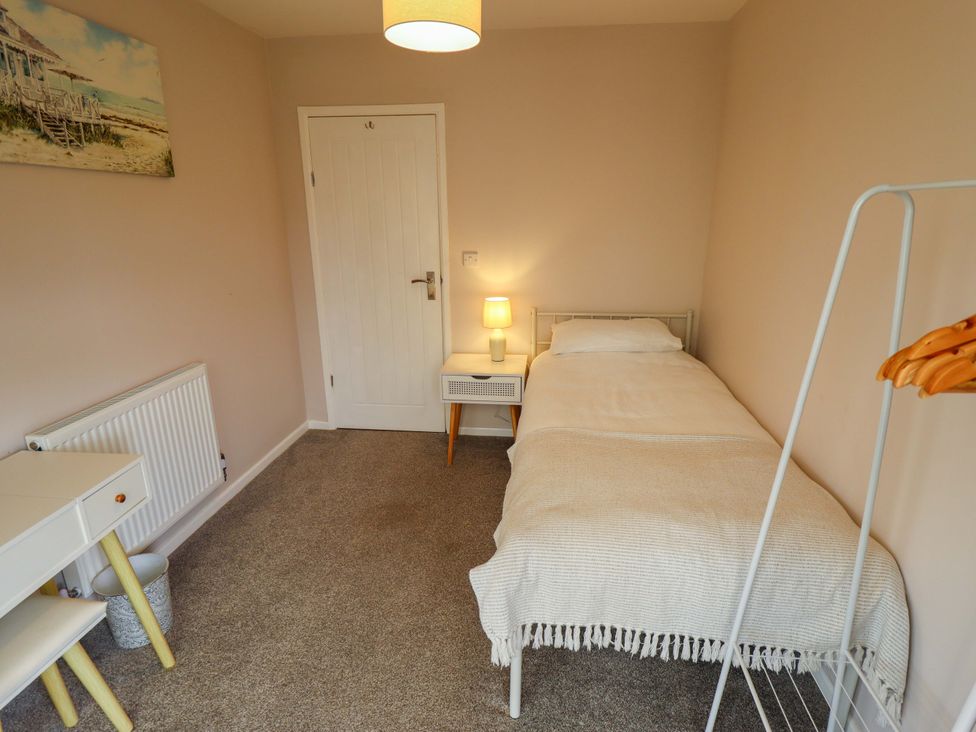 A bedroom with a single bed and side table at Field View in North Walsham