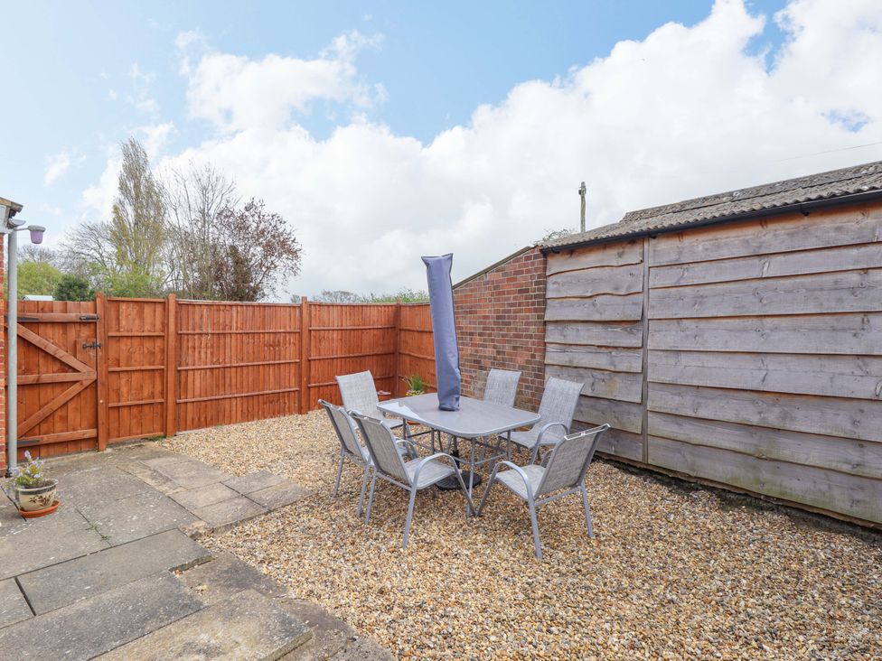 A garden with a table and chairs at Field View in North Walsham