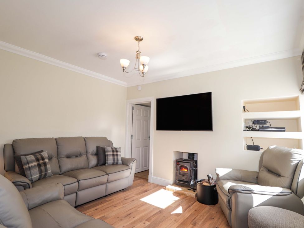 A living room with a sofa and fireplace at Craig Cottage in Banff