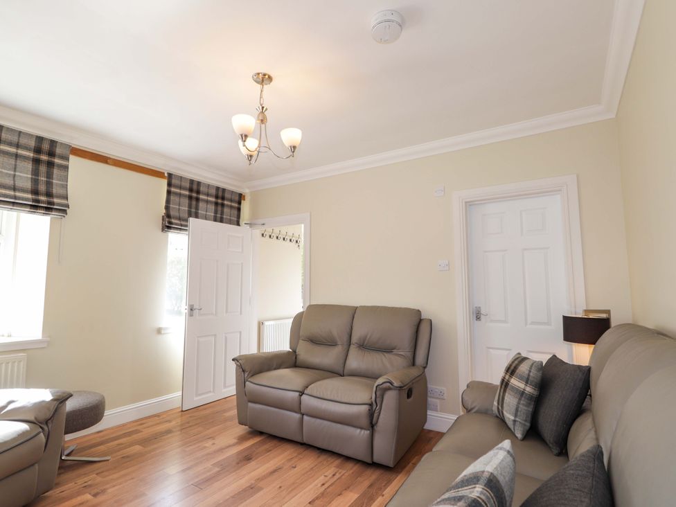 A living room with seating and a window at Craig Cottage in Banff