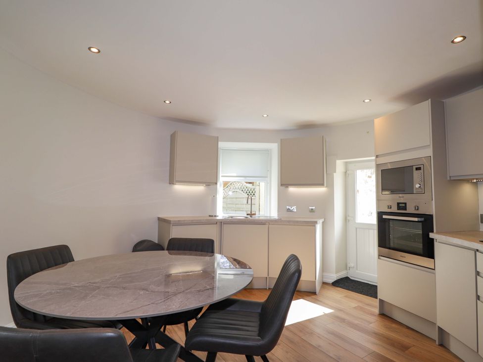 A kitchen with a dining table and chairs at Craig Cottage in Banff