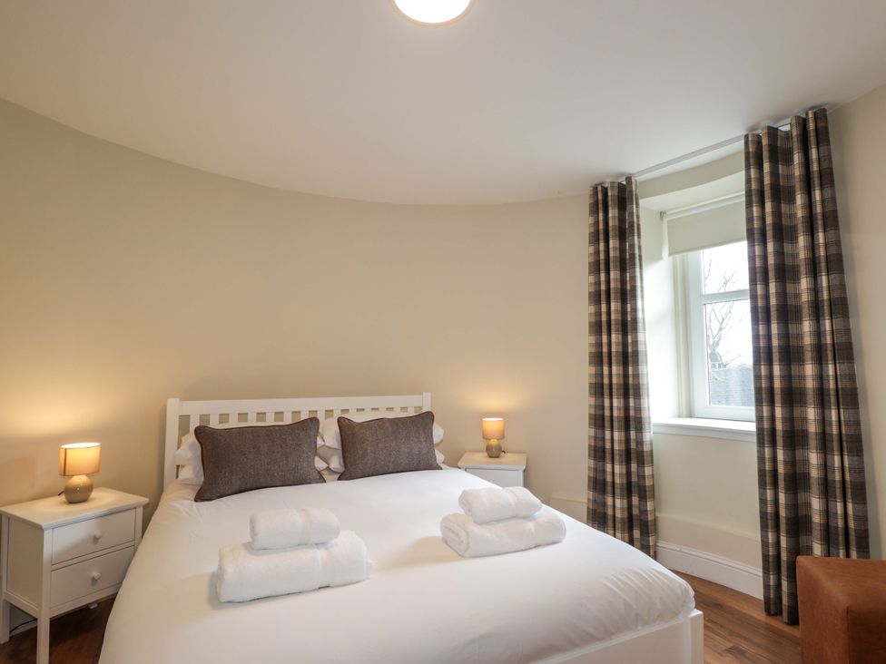 A bedroom with a double bed and side tables at Craig Cottage in Banff