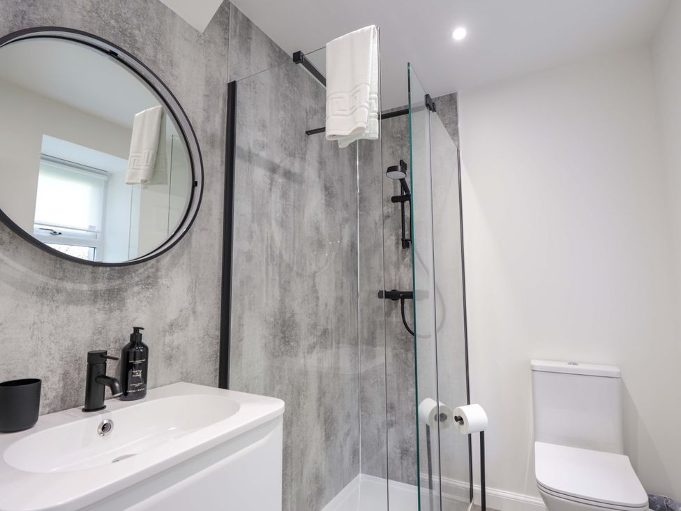 A bathroom with a sink, shower, and toilet at Craig Cottage in Banff