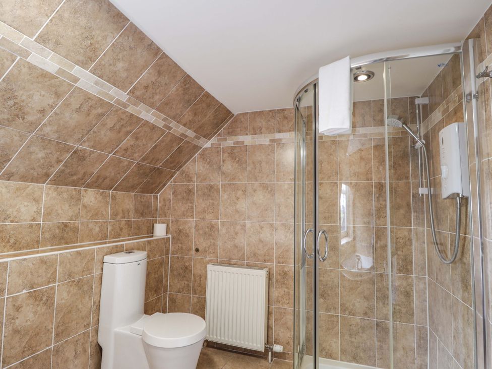 A bathroom with a shower and toilet at Craig Cottage in Banff
