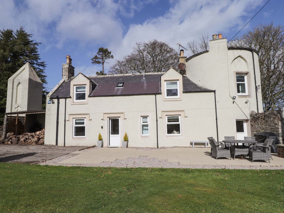 A house with patio furniture at Craig Cottage in Banff