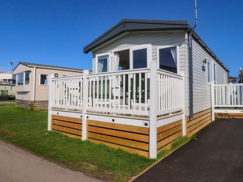 A mobile home with a deck and railing at Plot B2 Crozzers Place in Morecambe