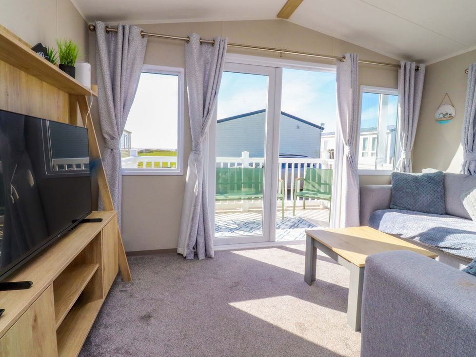 A living room with a television and sofa at Plot B2 Crozzers Place in Morecambe
