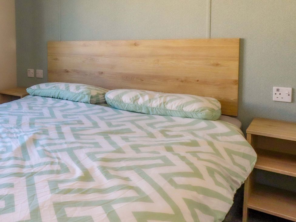 A bedroom with a bed and nightstand at Plot B2 Crozzers Place in Morecambe