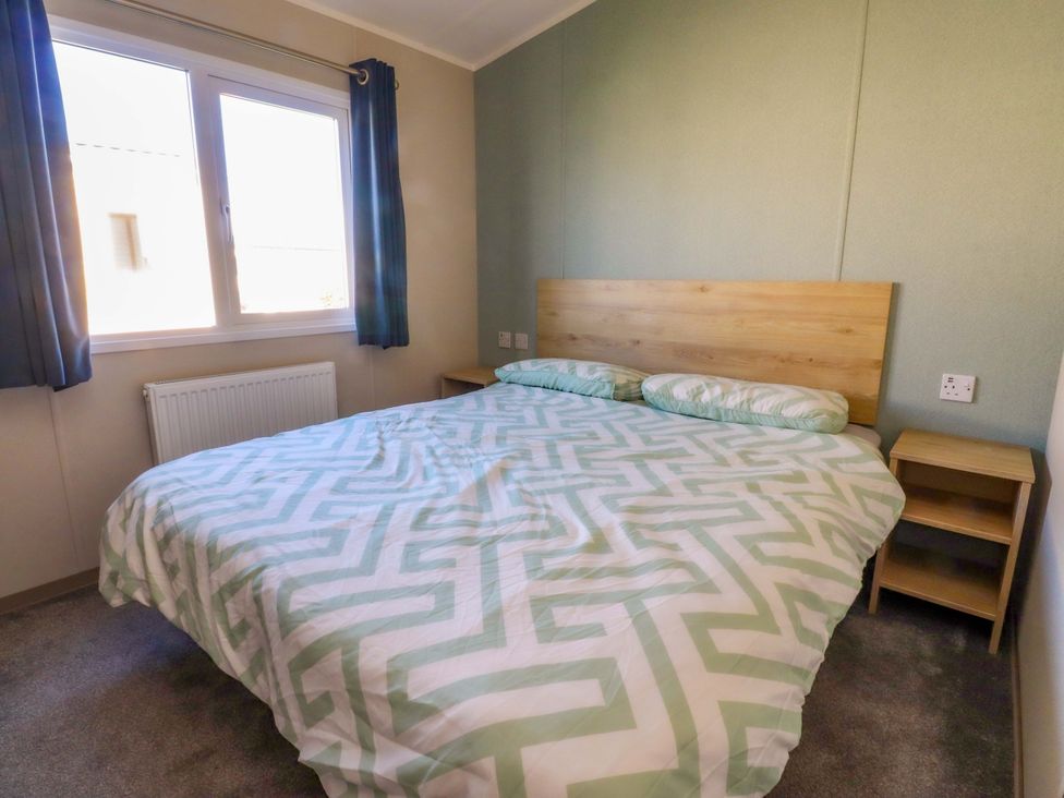 A bedroom with a bed and a bedside table at Plot B2 Crozzers Place in Morecambe
