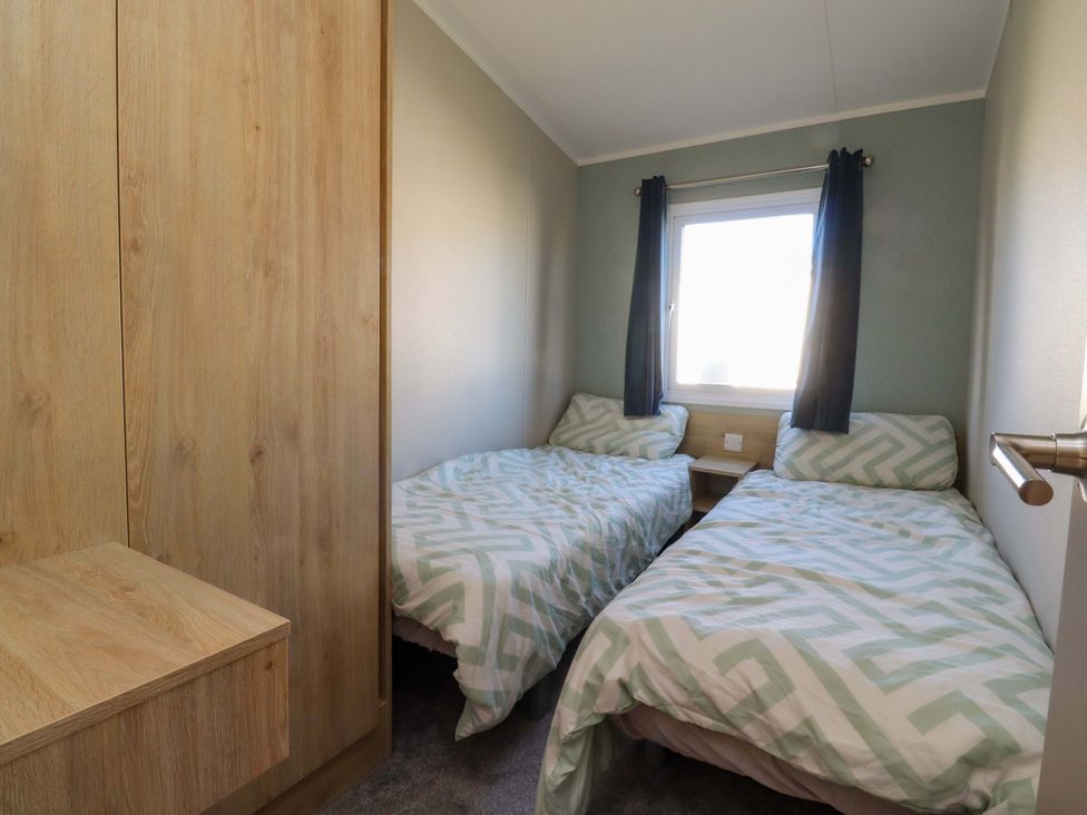 A bedroom with twin beds and a wardrobe at Plot B2 Crozzers Place in Morecambe