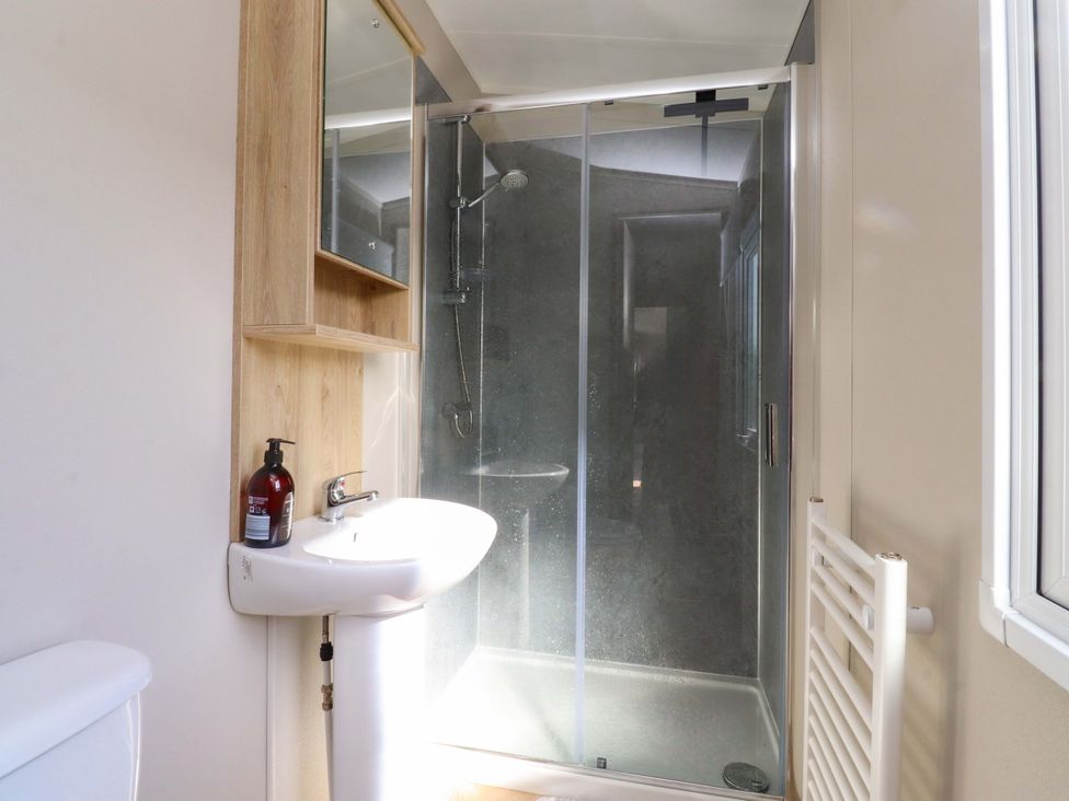 A bathroom with a sink, shower, and toilet at Plot B2 Crozzers Place in Morecambe