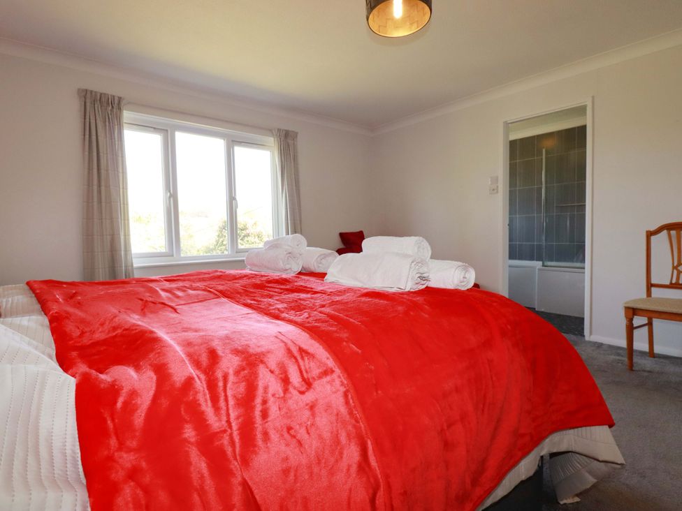 A bedroom with a bed and towels arranged on it at Tregoning in Lostwithiel