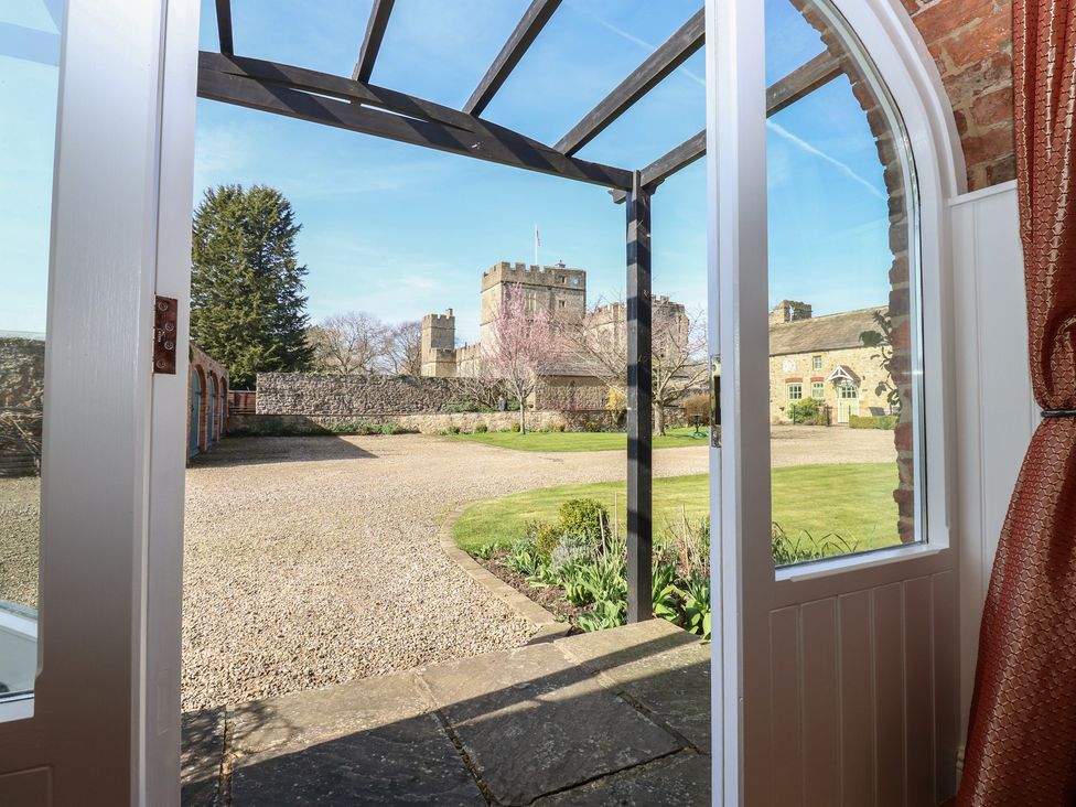 A view of a garden with a castle in the background at Castle View Cottage in Bedale