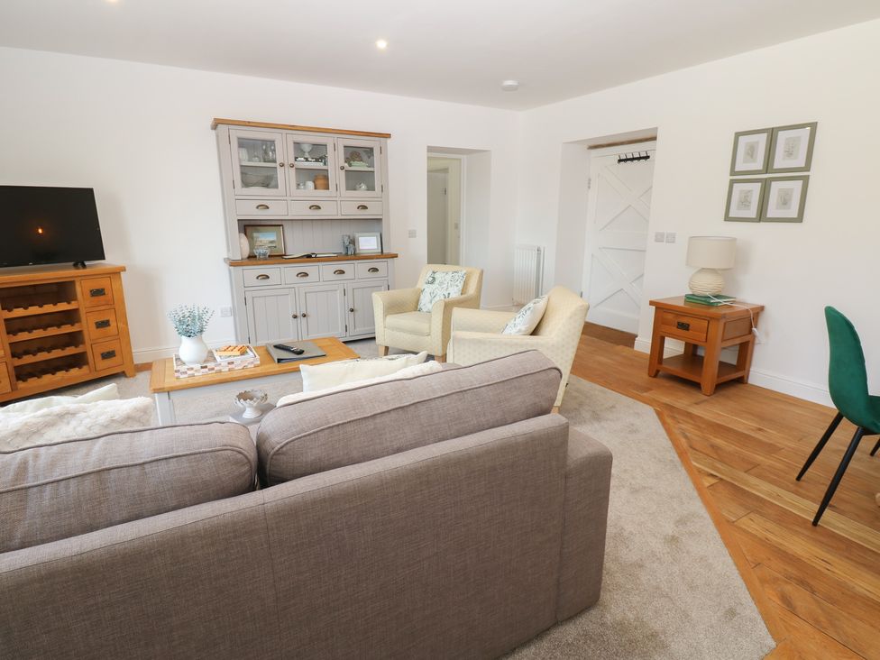 A living room with a television and sofa at Castle View Cottage in Bedale