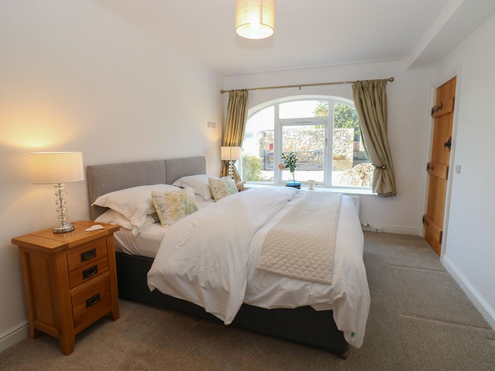 A bedroom with a bed and nightstand at Castle View Cottage in Bedale