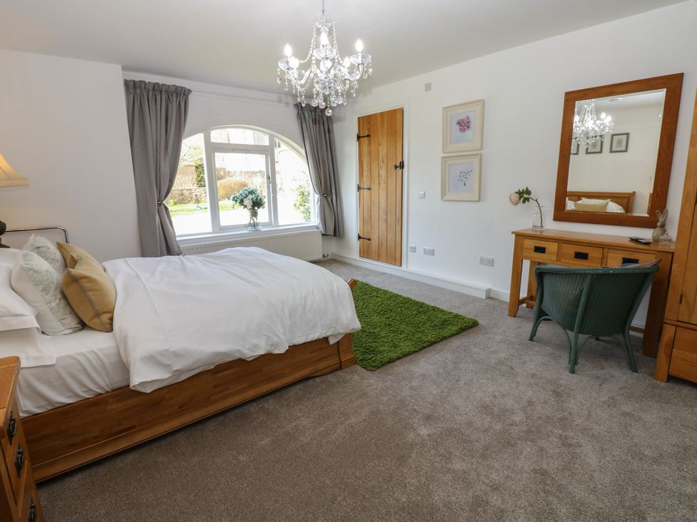 A bedroom with a bed and window at Castle View Cottage Bedale