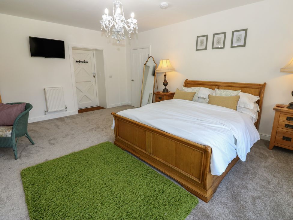 A bedroom with a bed and nightstand at Castle View Cottage Bedale