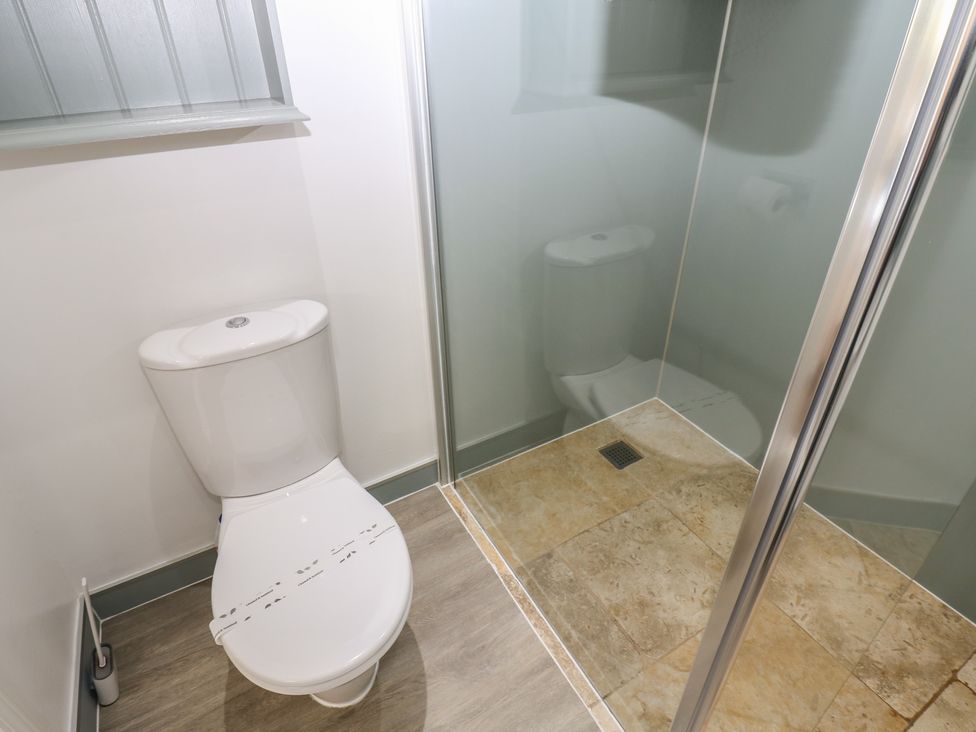 A bathroom with a toilet and shower at Castle View Cottage in Bedale