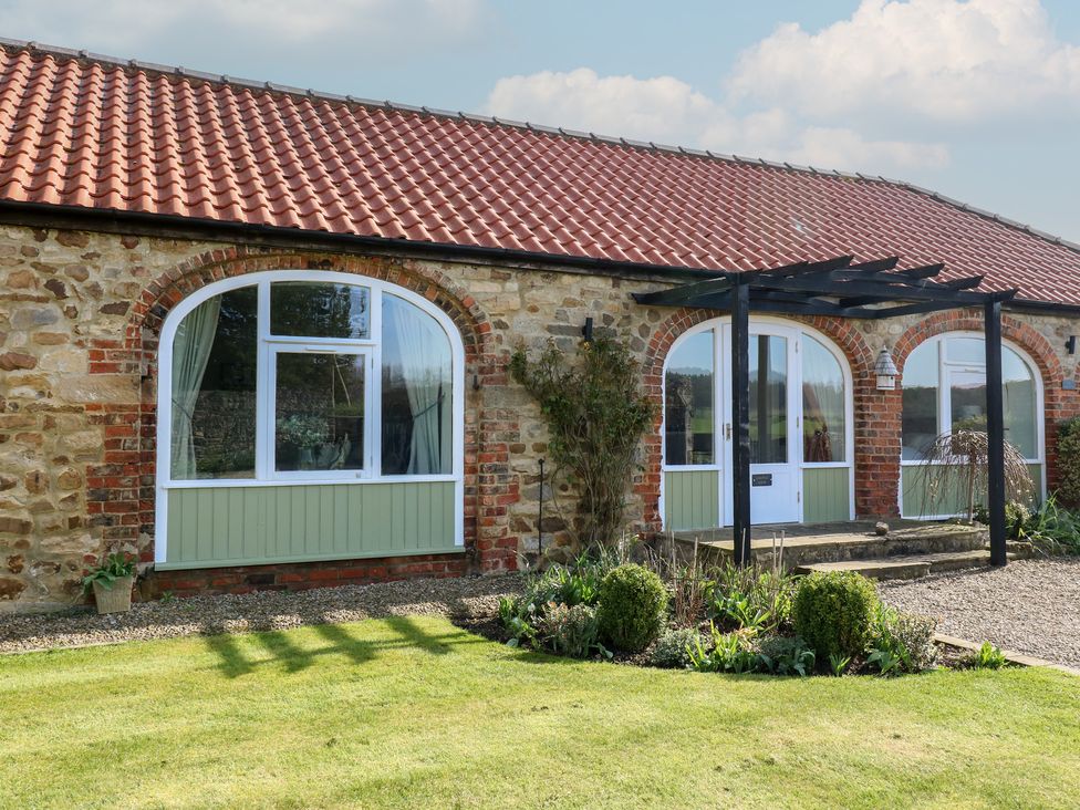 An exterior view of a stone cottage with a garden at Castle View Cottage Bedale
