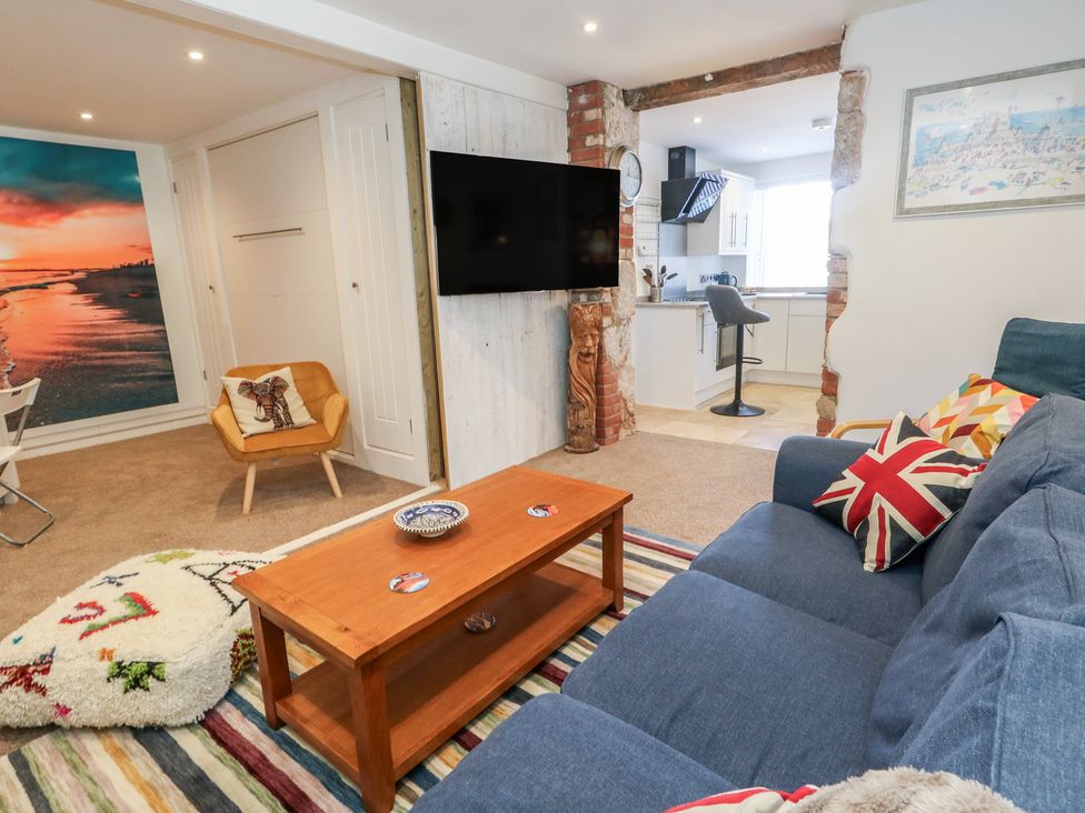 A living room with a sofa and coffee table at Tipsy Turtle in Weymouth